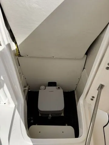 Slide: The Image of Interior of 2022 Robalo R222 Explorer featuring a toilet. - 24