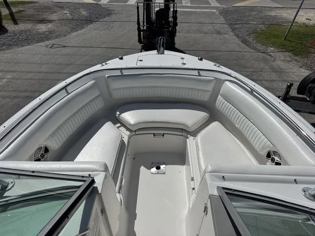 Slide: The Image of Interior view of a 2012 Robalo 247 DC boat with white seating. - 11