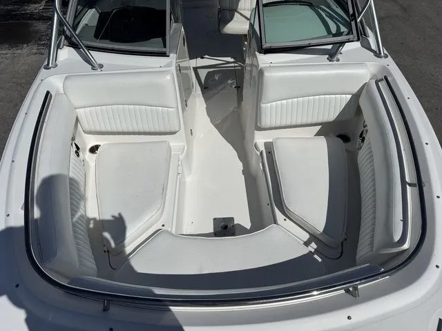 Slide: The Image of Interior view of a 2012 Robalo 247 DC boat with white seating. - 13