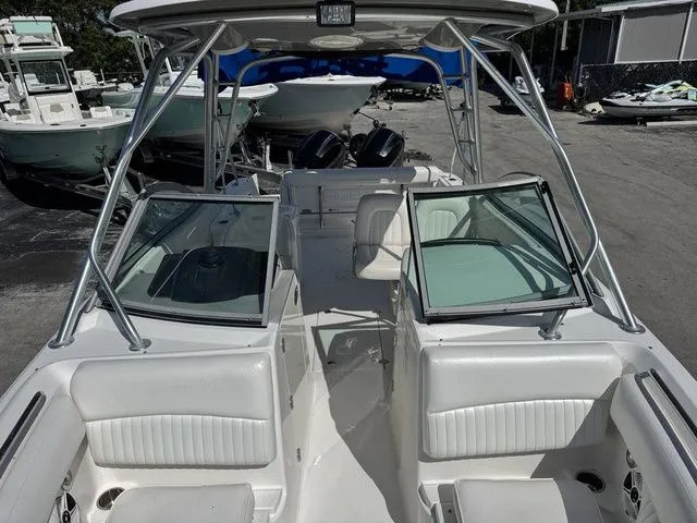Slide: The Image of 2012 Robalo 247 DC boat with open cockpit and seating area. - 14