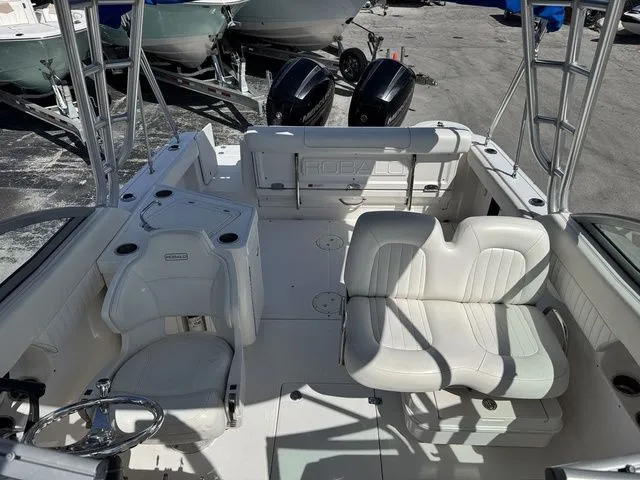 Slide: The Image of Interior view of a 2012 Robalo 247 DC boat with white seating. - 15