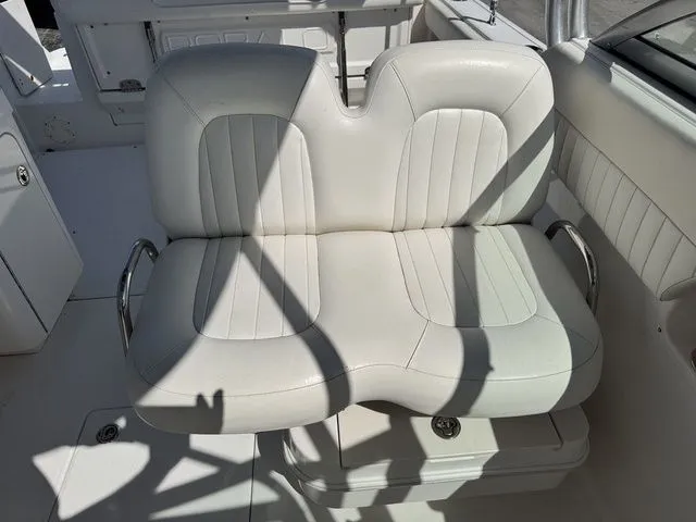 Slide: The Image of White double seat on a 2012 Robalo 247 DC boat. - 16