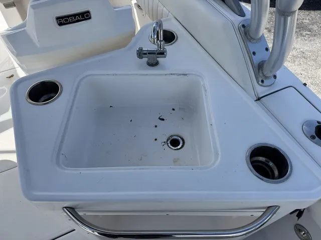 Slide: The Image of Sink on a 2012 Robalo 247 DC boat with cup holders. - 22