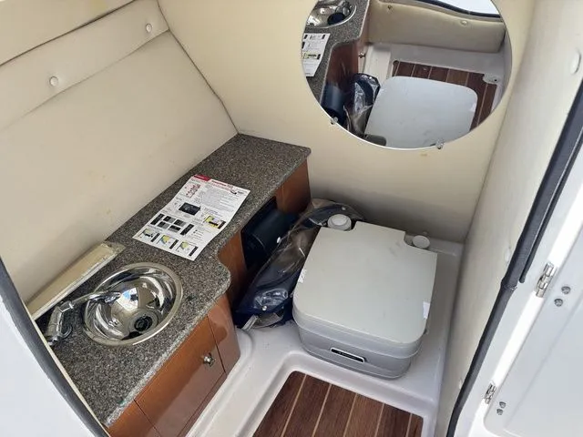 Slide: The Image of Interior of 2012 Robalo 247 DC boat with sink and toilet. - 24