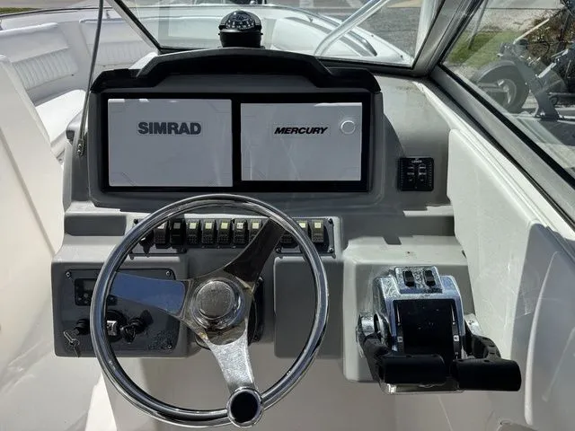 Slide: The Image of 2012 Robalo 247 DC boat helm with Simrad and Mercury equipment. - 25