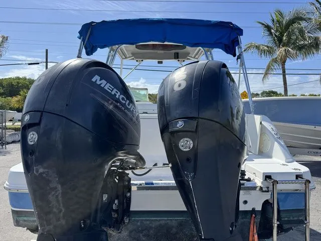 Slide: The Image of 2012 Robalo 247 DC with twin Mercury outboard engines, blue sunshade. - 5