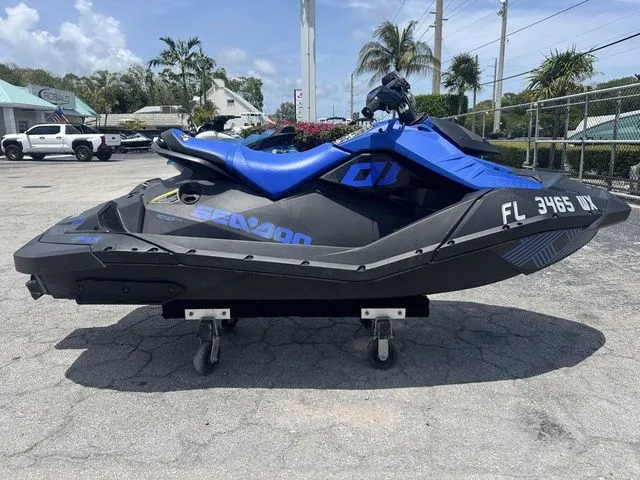 Slide: The Image of 2023 Sea-Doo Spark Trixx 2-up jet ski on parking lot. - 2