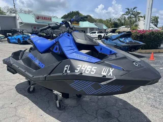 Slide: The Image of 2023 Sea-Doo Spark Trixx 2-up jet ski in blue on parking lot. - 3