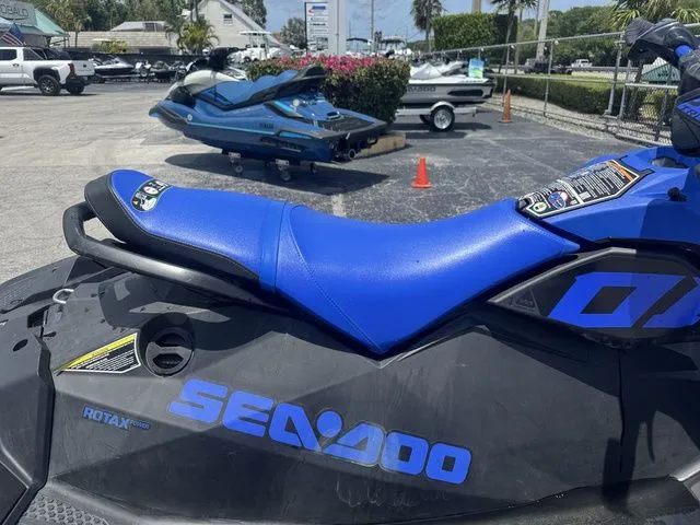 Slide: The Image of 2023 Sea-Doo Spark Trixx 2-up Jet Ski in blue on parking lot. - 9