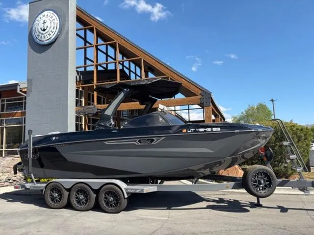 The Image of 2024 Tigé 23ZX boat on trailer in front of modern building. - 1