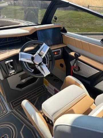 Slide: The Image of Interior of 2024 Tigé 23ZX boat with modern steering wheel and dashboard. - 5