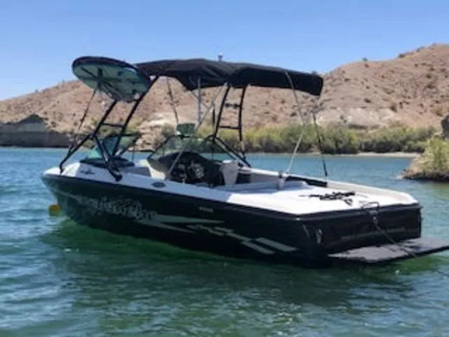 The Image of 2003 Centurion Avalanche boat on a calm lake. - 1