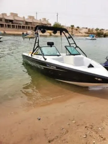 Slide: The Image of 2003 Centurion Avalanche boat on a sandy lakeshore. - 2