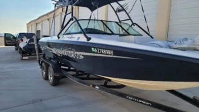 Slide: The Image of 2003 Centurion Avalanche boat on trailer in front of storage building. - 3