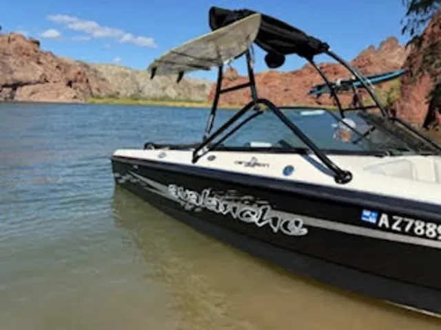 Slide: The Image of 2003 Centurion Avalanche boat by lakeside with rocky background. - 4