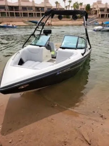 Slide: The Image of 2003 Centurion Avalanche boat parked on sandy shore. - 5