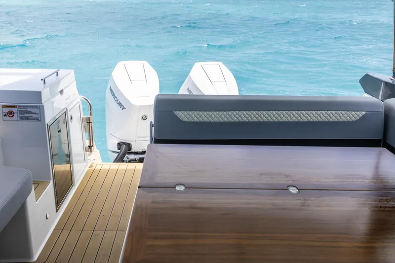 Slide: The Image of 2024 Beneteau Gran Turismo 36 yacht deck with twin Mercury outboard engines. - 18