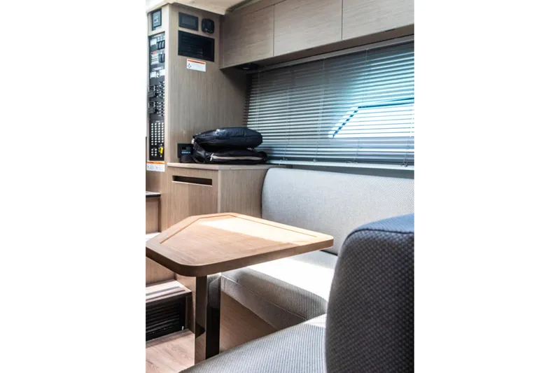 Slide: The Image of Interior of 2024 Beneteau Gran Turismo 36, featuring a modern seating area with wooden table. - 29