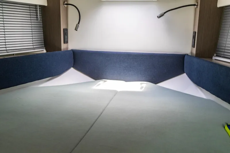 Slide: The Image of Interior cabin of 2024 Beneteau Gran Turismo 36 with cozy bedding and reading lights. - 25