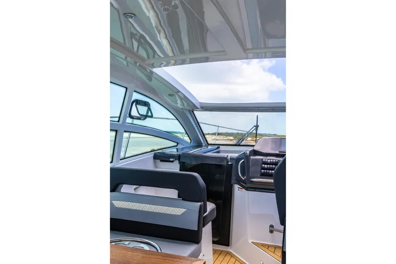 Slide: The Image of 2024 Beneteau Gran Turismo 36 cockpit with modern design and panoramic windows. - 13