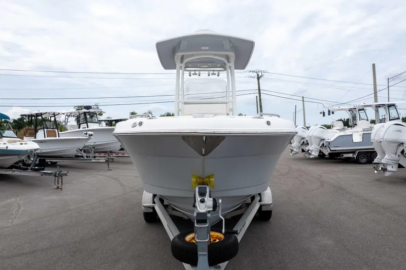 The Image of 2021 Robalo R222 Center Console boat on trailer in a dealership lot. - 1