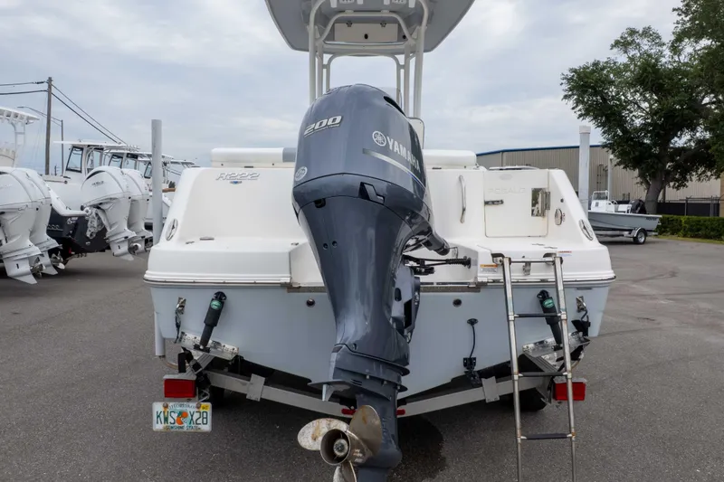 Slide: The Image of 2021 Robalo R222 Center Console boat with Yamaha 200 engine, parked in a marina. - 12
