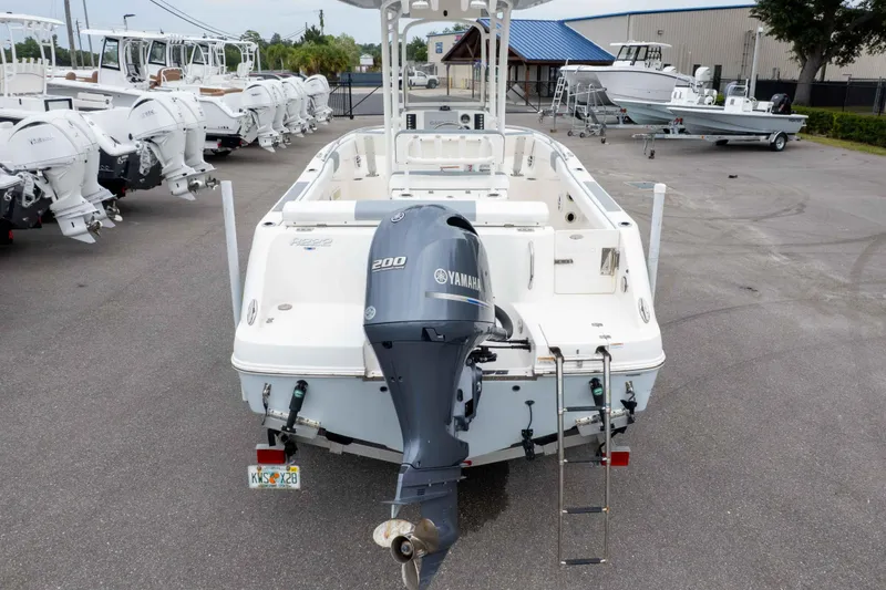 Slide: The Image of 2021 Robalo R222 Center Console boat with Yamaha 200 engine, parked in a marina. - 13
