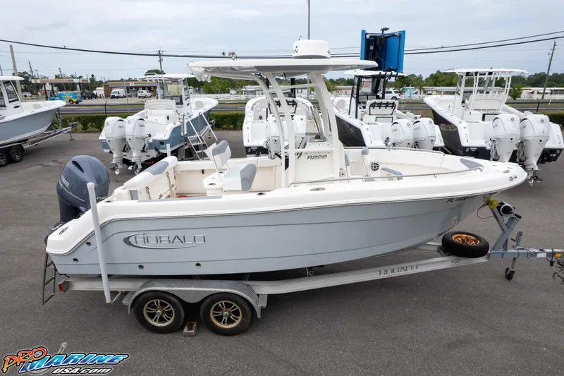 Slide: The Image of 2021 Robalo R222 Center Console boat on trailer at dealership, surrounded by other boats. - 18
