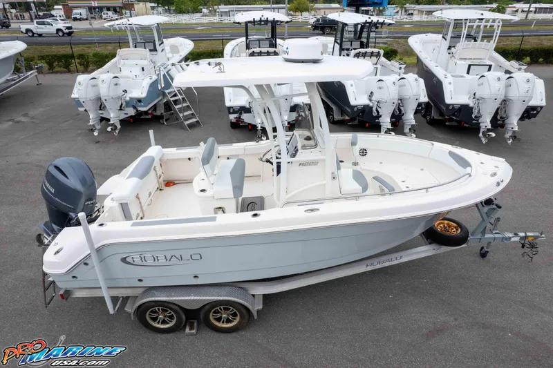 Slide: The Image of 2021 Robalo R222 Center Console boat on trailer, surrounded by other boats. - 19