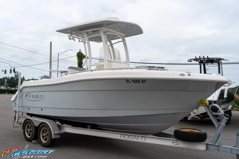 Slide: The Image of 2021 Robalo R222 Center Console boat on trailer, parked outdoors. - 27