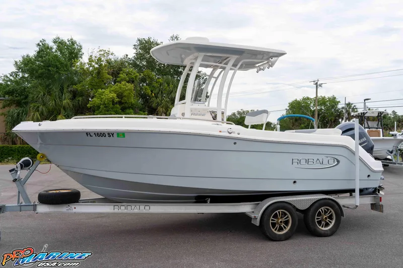 Slide: The Image of 2021 Robalo R222 Center Console boat on trailer, parked outdoors. - 32