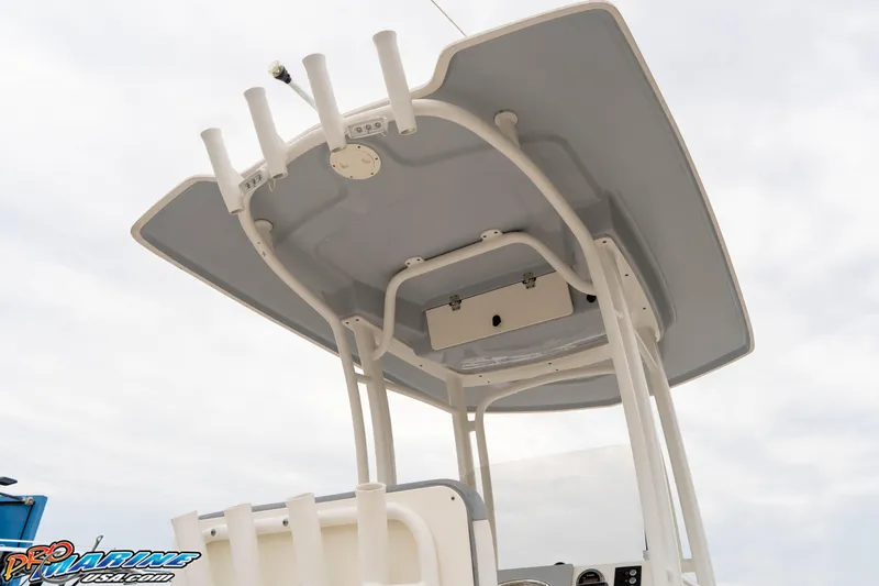 Slide: The Image of 2021 Robalo R222 Center Console boat's T-top with rod holders and storage. - 38