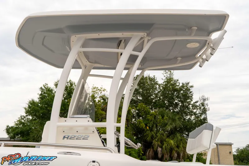 Slide: The Image of 2021 Robalo R222 Center Console boat with T-top, viewed from the side. - 39