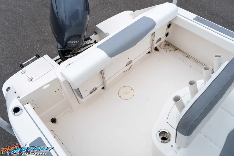 Slide: The Image of 2021 Robalo R222 Center Console boat interior with Yamaha 200 engine, rod holders, and seating. - 41