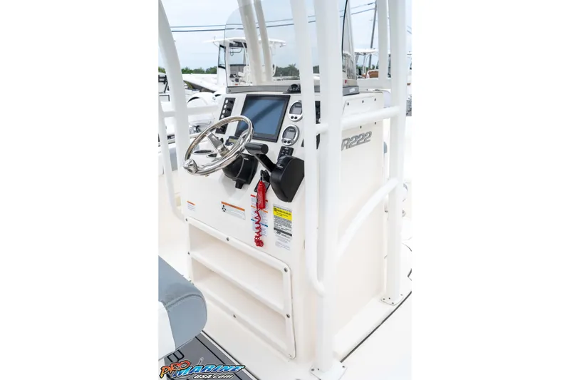 Slide: The Image of 2021 Robalo R222 Center Console boat dashboard with steering wheel and controls. - 44