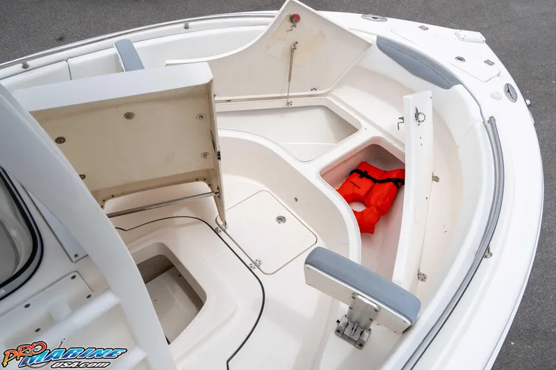 Slide: The Image of 2021 Robalo R222 Center Console boat interior with storage compartments and life jacket. - 47