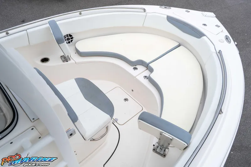 Slide: The Image of 2021 Robalo R222 Center Console boat interior with cushioned seating and storage compartments. - 48