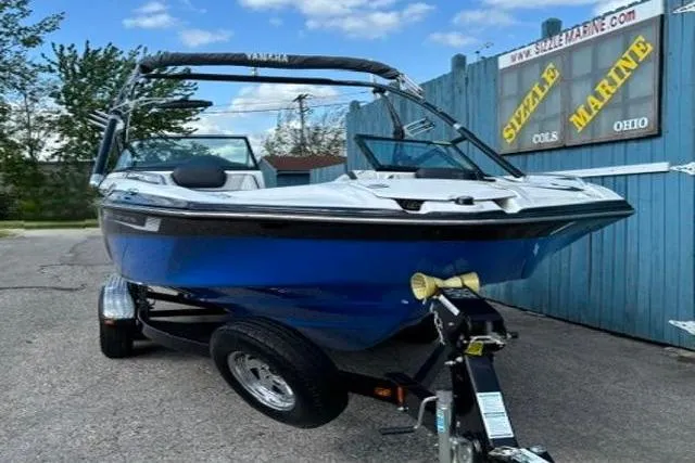 Slide: The Image of 2016 Yamaha Boats 212X in blue, parked on a trailer at Sizzle Marine, Ohio. - 1