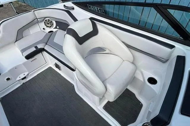 Slide: The Image of Interior of 2016 Yamaha Boats 212X, featuring sleek white seating and modern design elements. - 16
