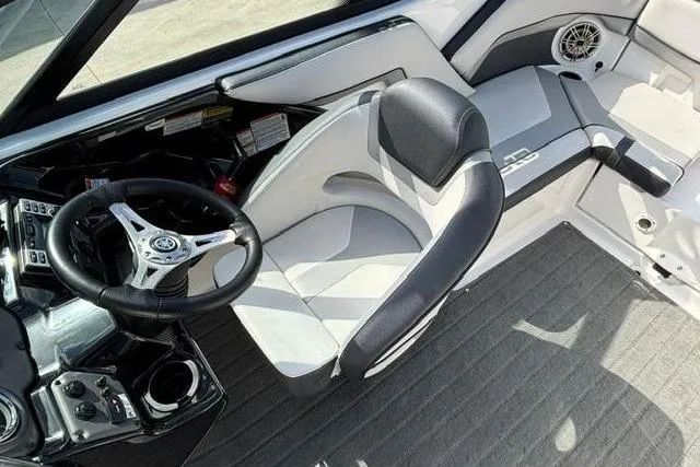Slide: The Image of 2016 Yamaha Boats 212X cockpit with steering wheel and seating, featuring modern design elements. - 19