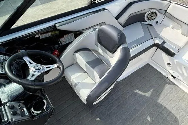 Slide: The Image of Interior of a 2016 Yamaha Boats 212X, featuring sleek seating and modern controls. - 20