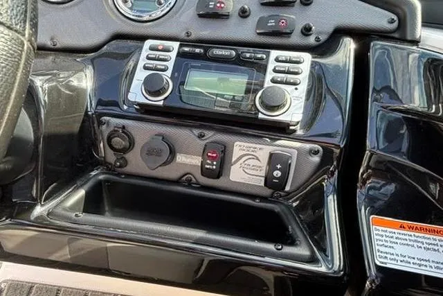 Slide: The Image of Control panel of a 2016 Yamaha Boats 212X, featuring audio system and controls. - 23