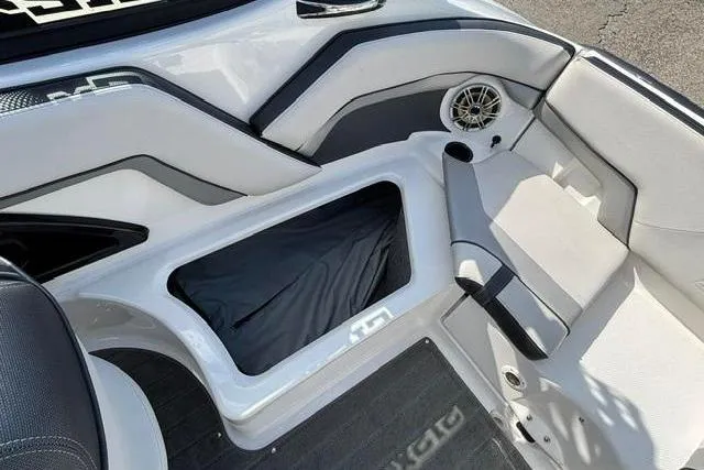 Slide: The Image of Interior view of a 2016 Yamaha Boats 212X, featuring seating and storage compartments. - 28
