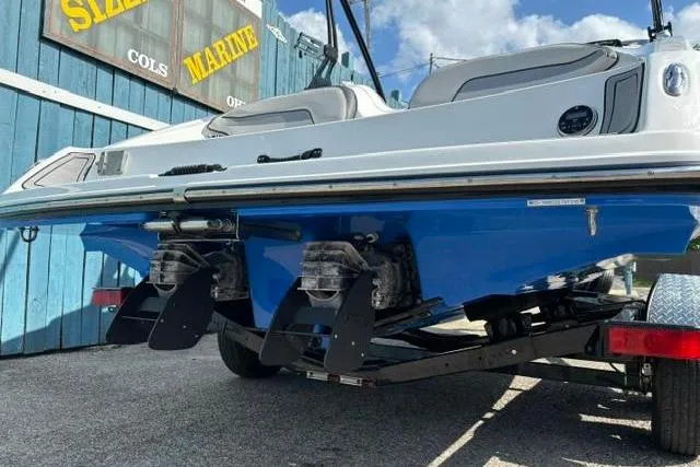 Slide: The Image of 2016 Yamaha Boats 212X on trailer, showcasing dual engines and sleek blue hull. - 5