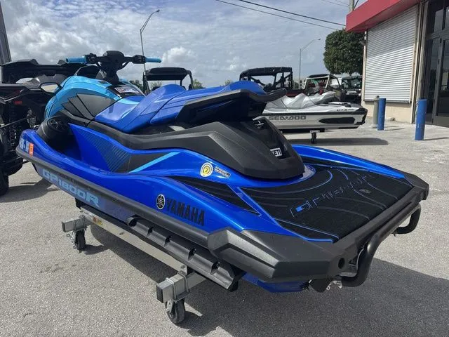 Slide: The Image of 2023 Yamaha WaveRunner GP1800R in blue on a parking lot. - 6