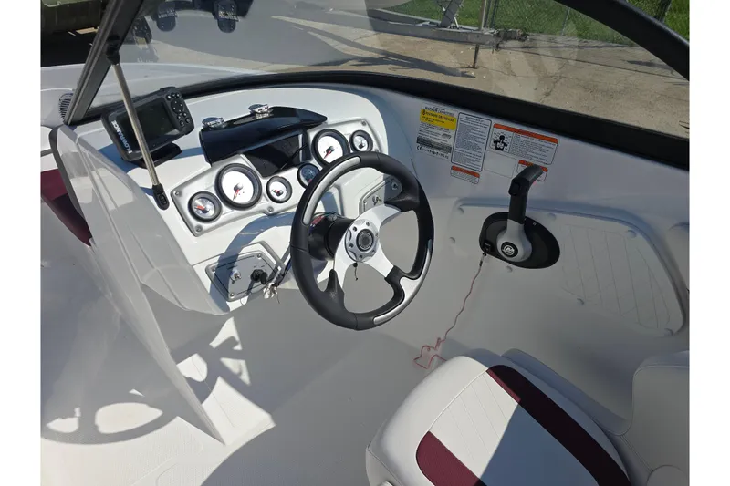 Slide: The Image of Cockpit of 2020 Tahoe 500 TF boat with steering wheel and control panel. - 10