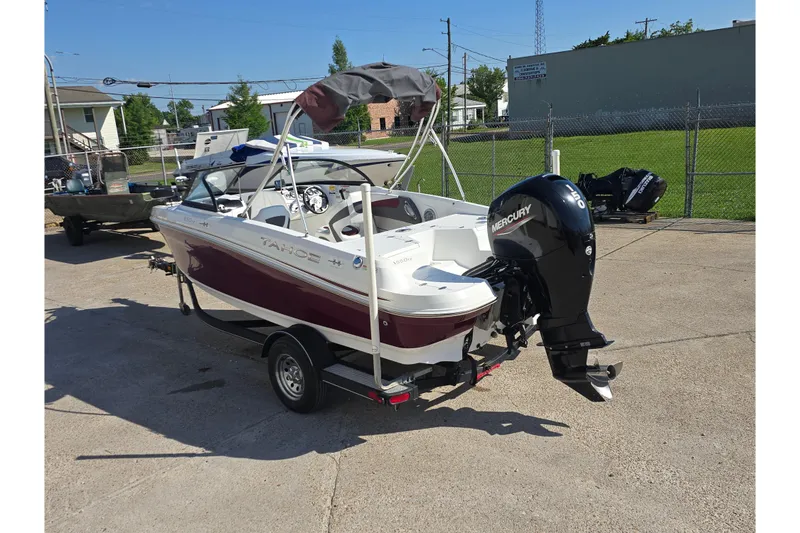 Slide: The Image of 2020 Tahoe 500 TF boat with Mercury engine on trailer in outdoor setting. - 4