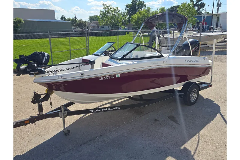 Slide: The Image of 2020 Tahoe 500 TF boat on trailer, parked outdoors under sunny skies. - 5