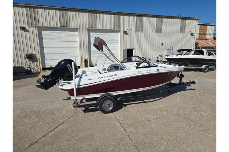 Slide: The Image of 2020 Tahoe 500 TF boat on trailer, parked outside a warehouse. - 6