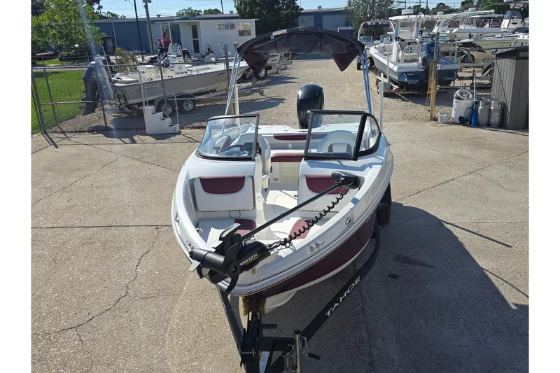 Slide: The Image of 2020 Tahoe 500 TF boat on trailer, parked in marina with other boats. - 7